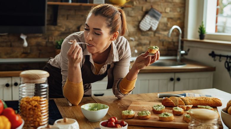 man feeding woman from wooden spoon