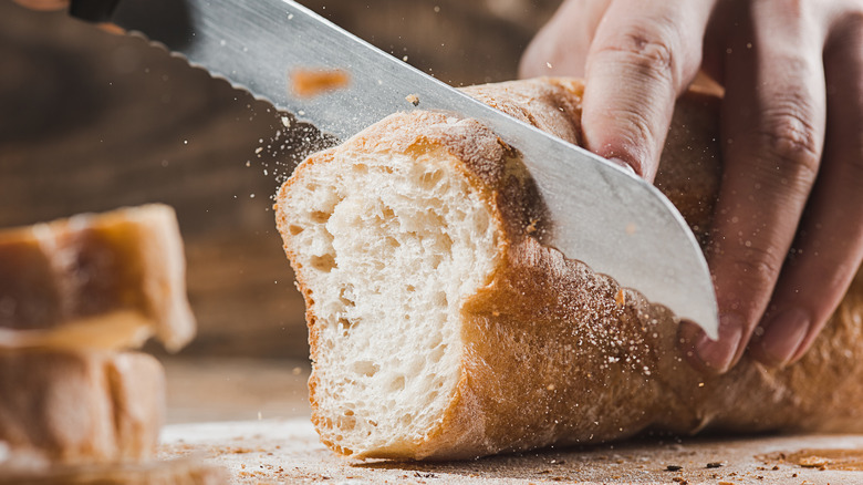Serrate knife slicing bread 