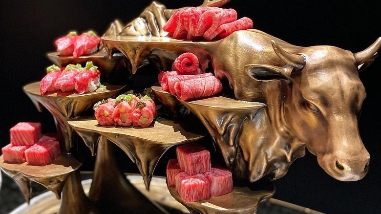 The X Pot Wagyu Feast on gold cow sculpture