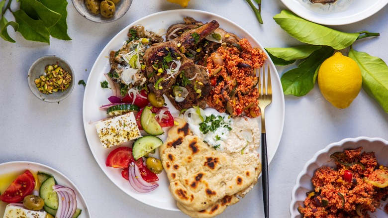 Modern Greek feast with pita, dips, and lemon