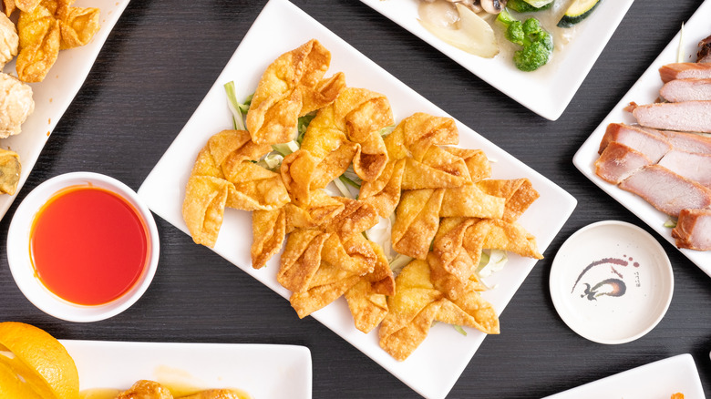 Plate of crab rangoon with other Chinese appetizers