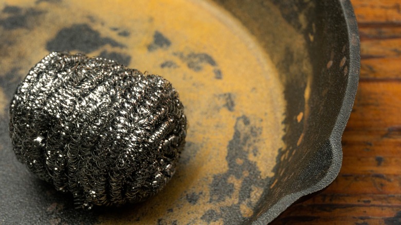 A steel wool scrub on a cast iron pan