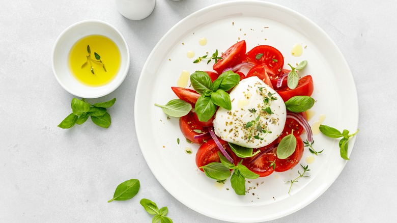 White plate with caprese salad