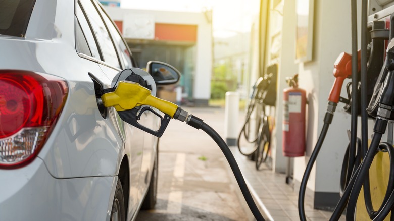 car at gas pump being fueled