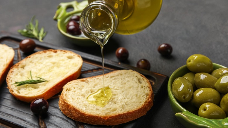 Olive oil being poured over bread