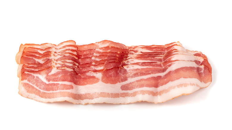 raw bacon on white background