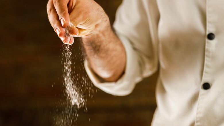 chef seasoning a dish