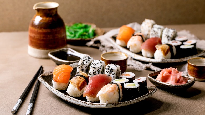 Platters of sushi and chopsticks