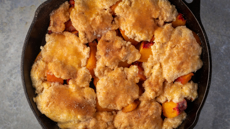 peach cobbler in a cast iron pan