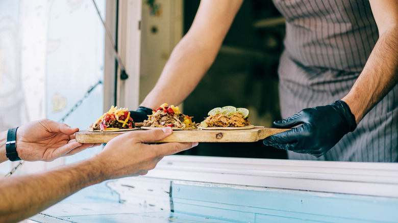 Food truck worker serving food