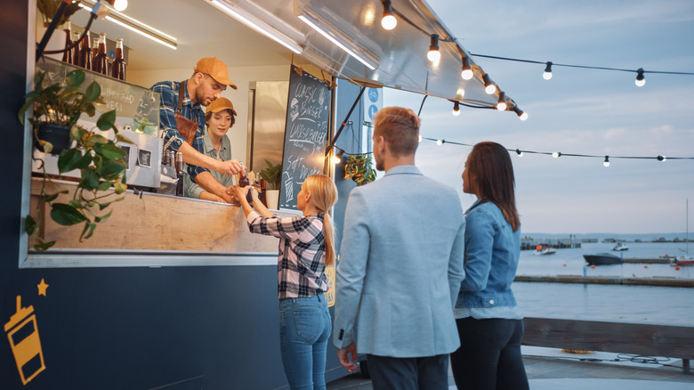 Food truck workers serving drinks