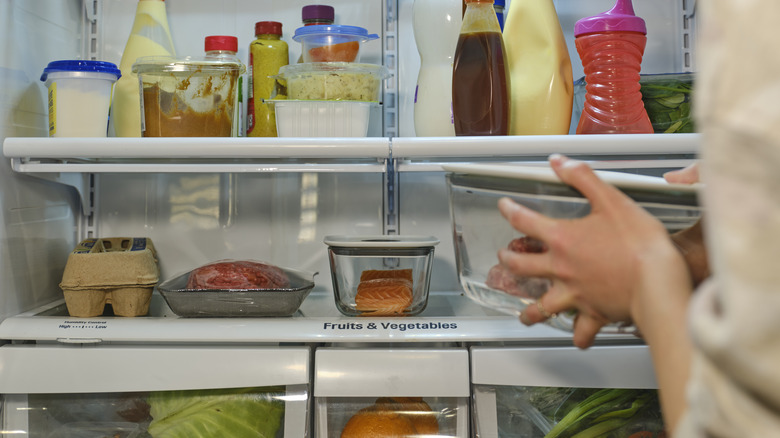 meat and eggs on refrigerator bottom shelf