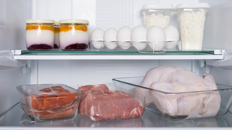 raw meat in glass containers in fridge