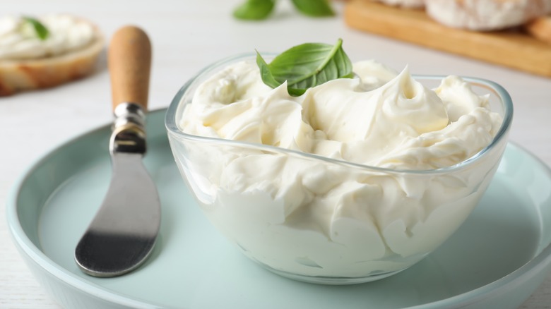 Dish of cream cheese with spreading knife