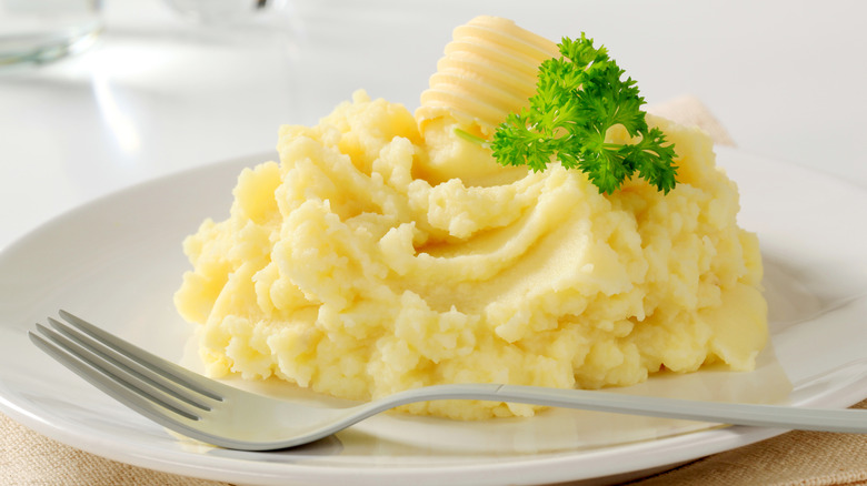 Wooden spoon of mashed potatoes