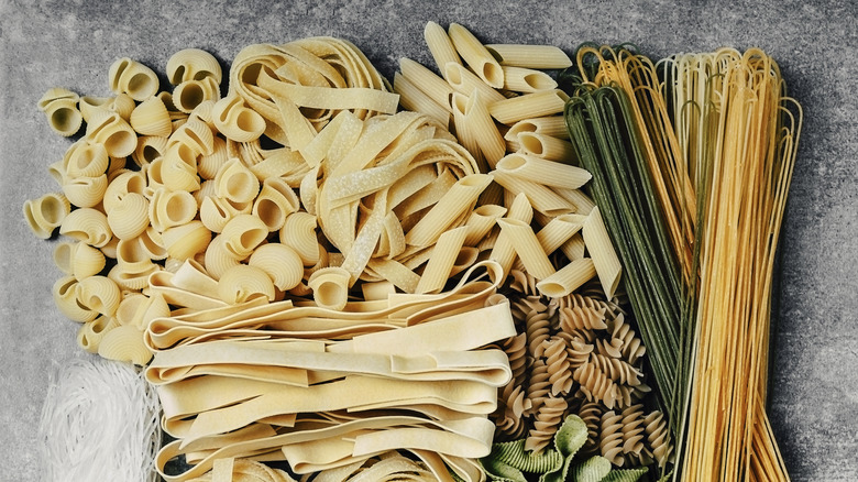 A close-up of a variety of dried pastas on a table.