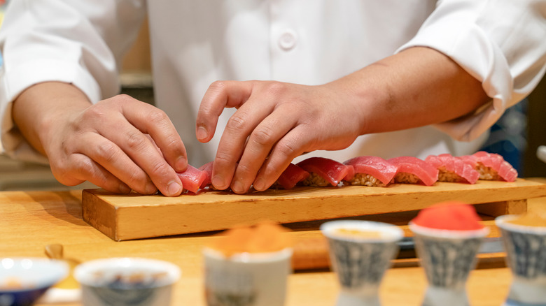 chef preparing sushi at restaurant