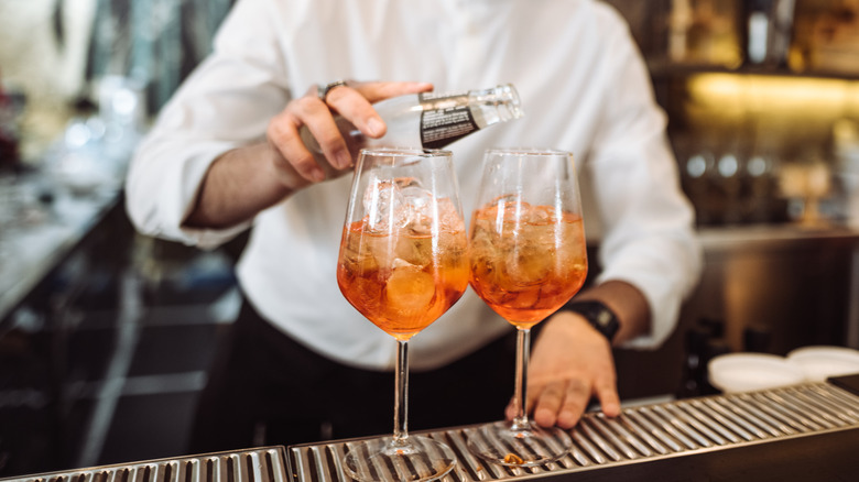 Topping off an Aperol spritz