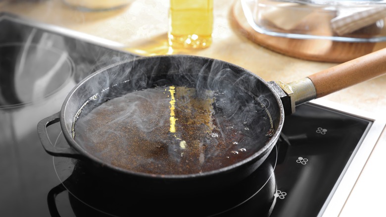 Pan on stovetop filled with hot smoking oil