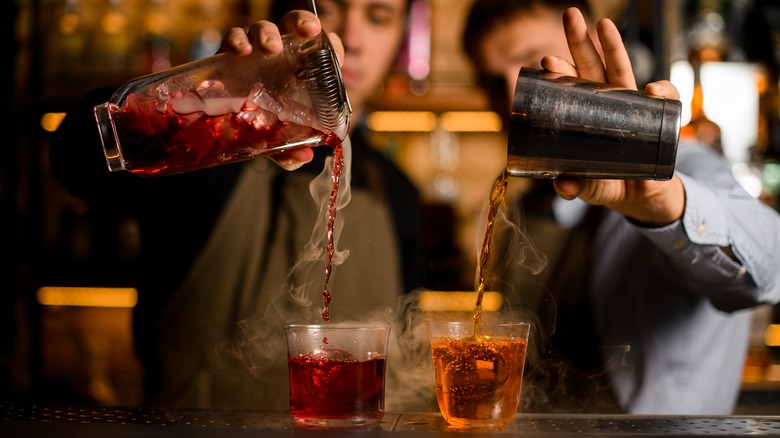 Bartenders preparing smoky cocktails