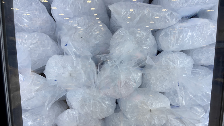 bags of packaged strore-bought ice inside a refrigerator