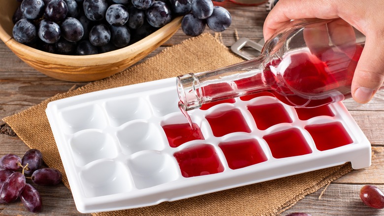 Pouring wine in ice cubes 