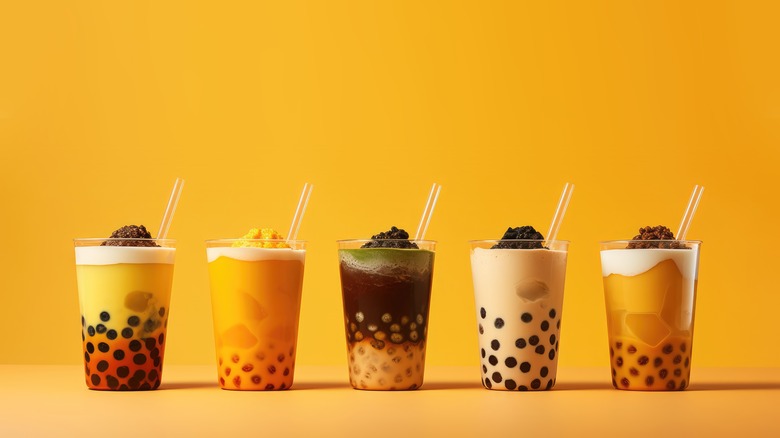 Bubble teas against a yellow backdrop