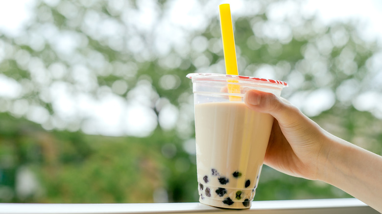 Person holding a glass of bubble tea