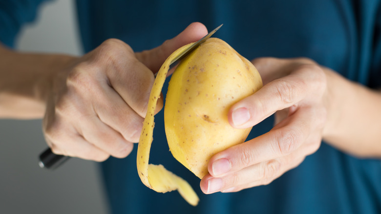 Peeling yellow potato