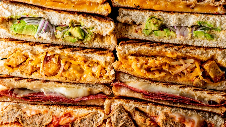 grilled stacked sandwiches full of meat and cheese