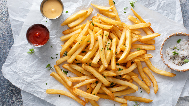 cooked french fries with condiments