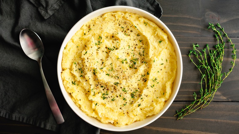 Well seasoned bowl of mashed potatoes with spoon