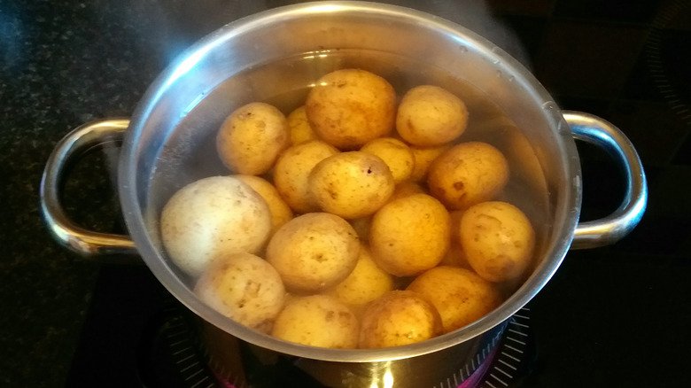 Pot of skin-on potatoes and water on stove