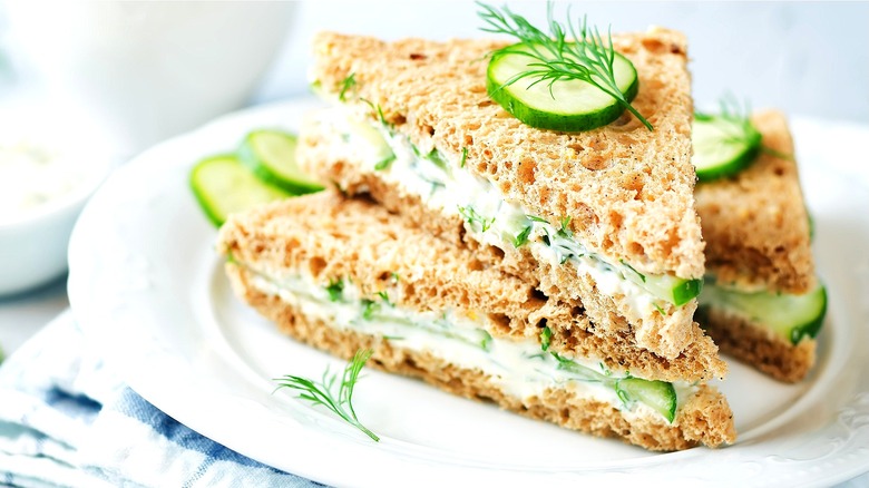 Cucumber tea sandwich with fresh herbs on brown bread