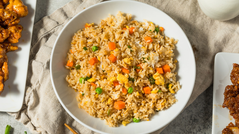 traditional chinese fried rice in a white bowl on a table cloth