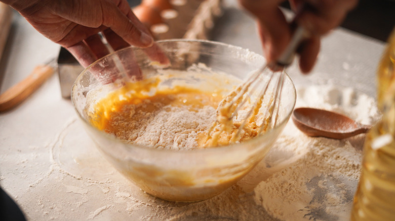 mixing bowl with batter and whisk