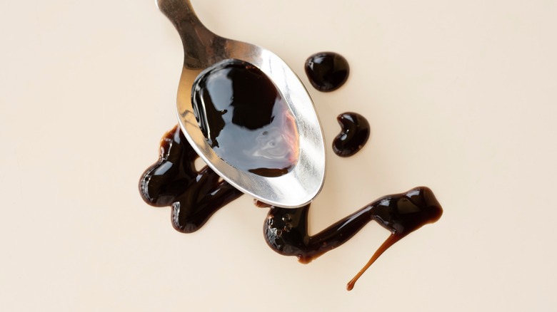 spoonful of balsamic vinegar hovering above drizzle