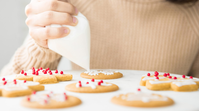 Hand decorating cookies with royal icing