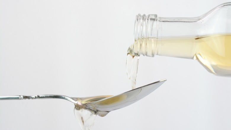 Vinegar pouring onto spoon