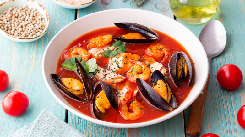 Bouillabaisse seafood soup in a white bowl with a spoon