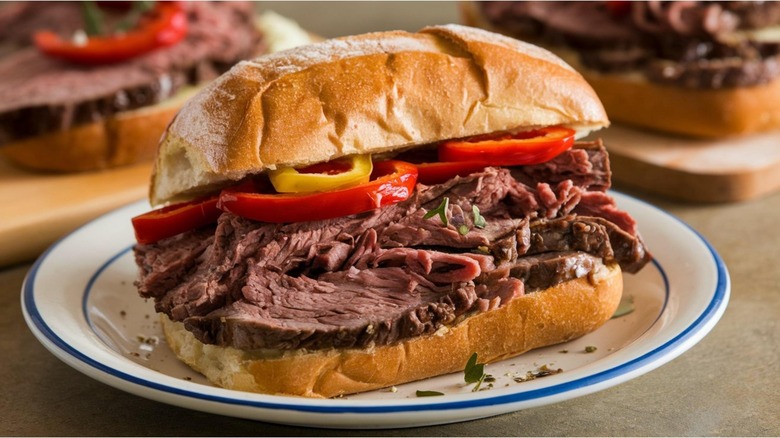 Italian beef sandwich with other sandwiches in the background