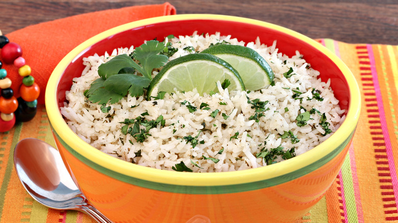 Cilantro and lime white rice in an orange Mexican style ceramic bowl