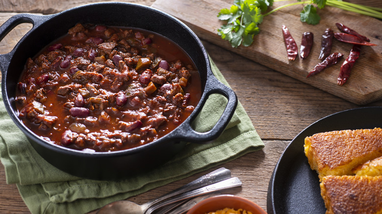 Southwestern chili in cast iron skillet with side of corn bread