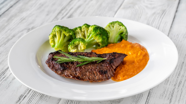 A plate of steak with sides.