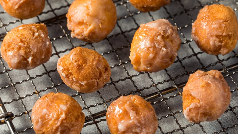 Glazed donut holes on wire rack