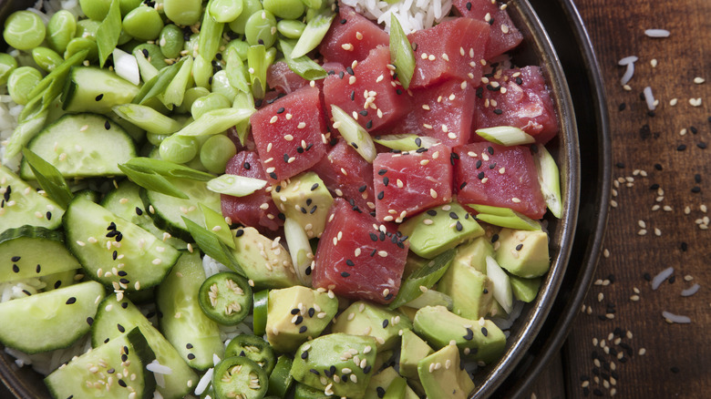 poke bowl with sliced cucumber, edamame, and green onion