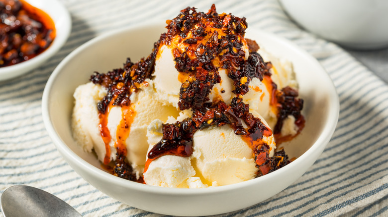 Bowl of vanilla ice cream topped with chili crisp hot sauce