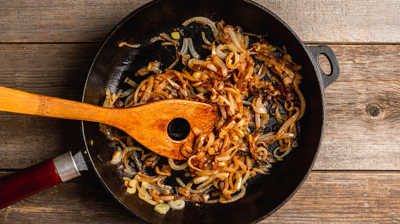 caramelized onions cooking in a cast iron skillet