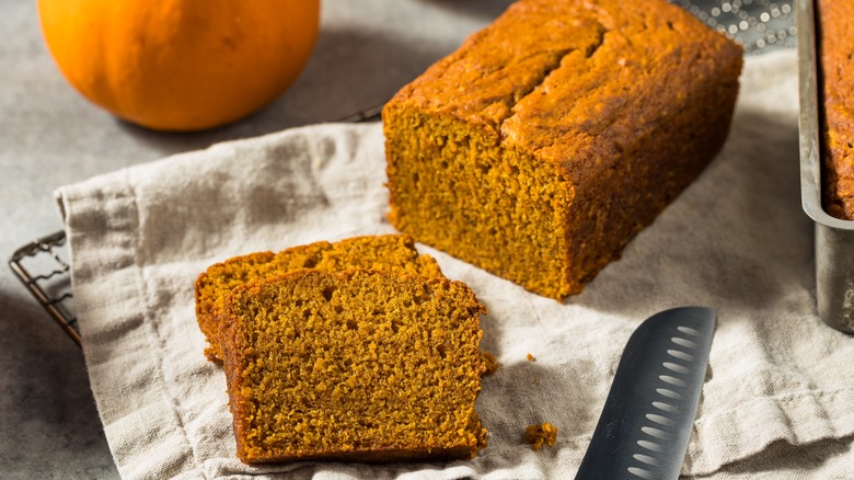 A sliced loaf of pumpkin bread ready to eat