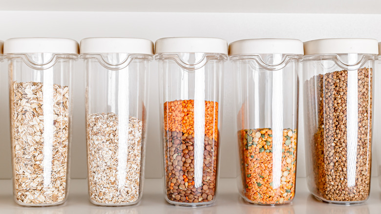 A line of clear plastic bins filled with non-perishable goods